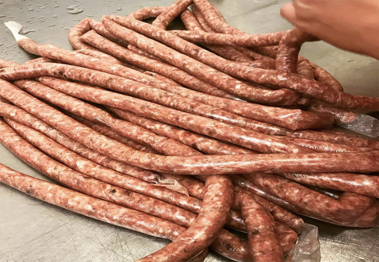 Links of fresh house sausage on the counter
