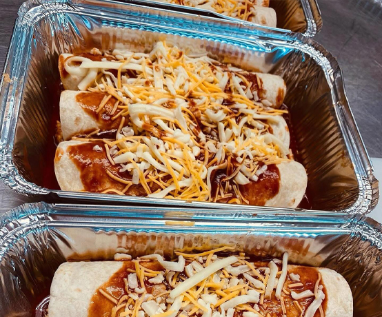 Cheese-topped enchiladas in foil pans